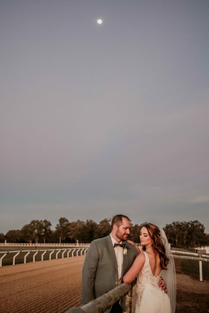 bride and groom on horse racetrack at Protea Weddings and Events