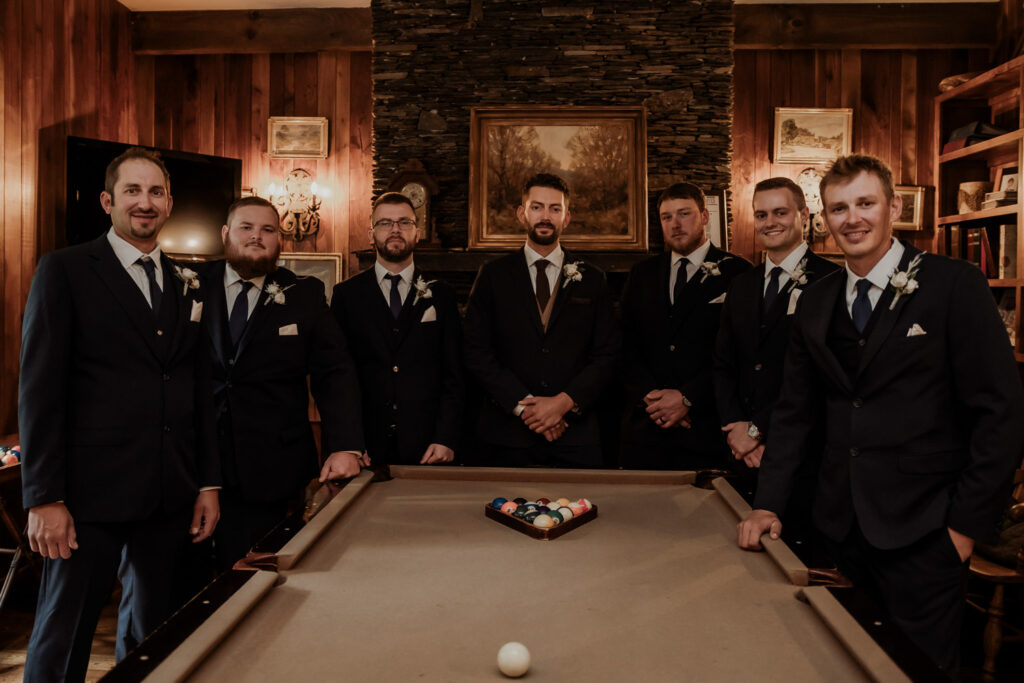 Cozy groom's suite with a wood-burning fireplace and billiards table.
