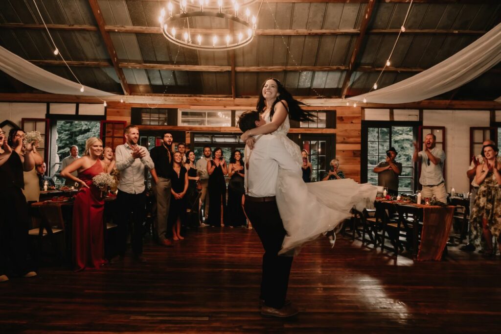 Epic choreographed first dance featuring spins, dips, and lifts at a fairytale riverside wedding