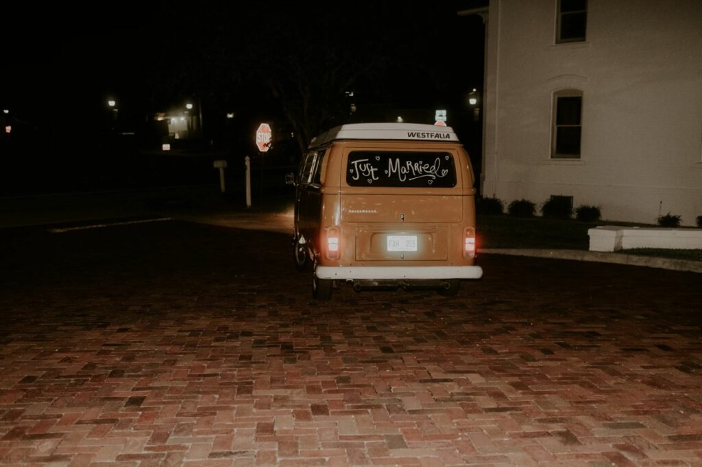 Departure as the couple drives away in a Vintage Westfalia Volkswagen bus from White Chapel & Harbor Hall.