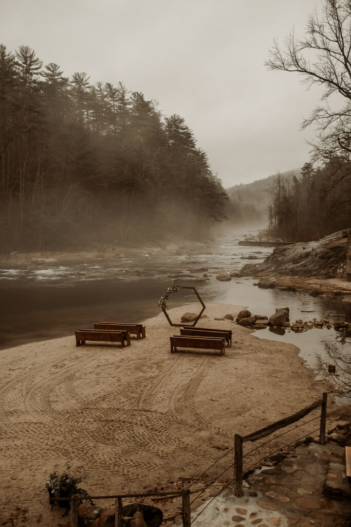 Foggy scene showing wedding ceremony setup along the river at Brown Mountain Beach Resort with mountains as the backdrop