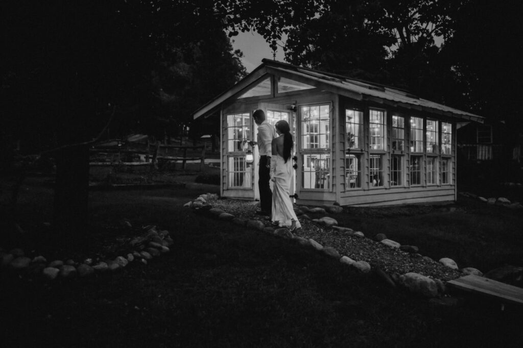 bride and groom entering candlelit greenhouse at Brown Mountain Beach Resort