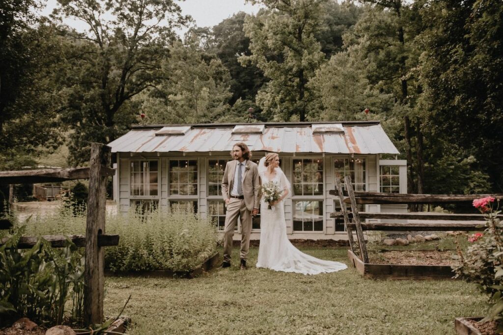 bride and groom holding hands in front of greenhouse at Brown Mountain Beach Resort