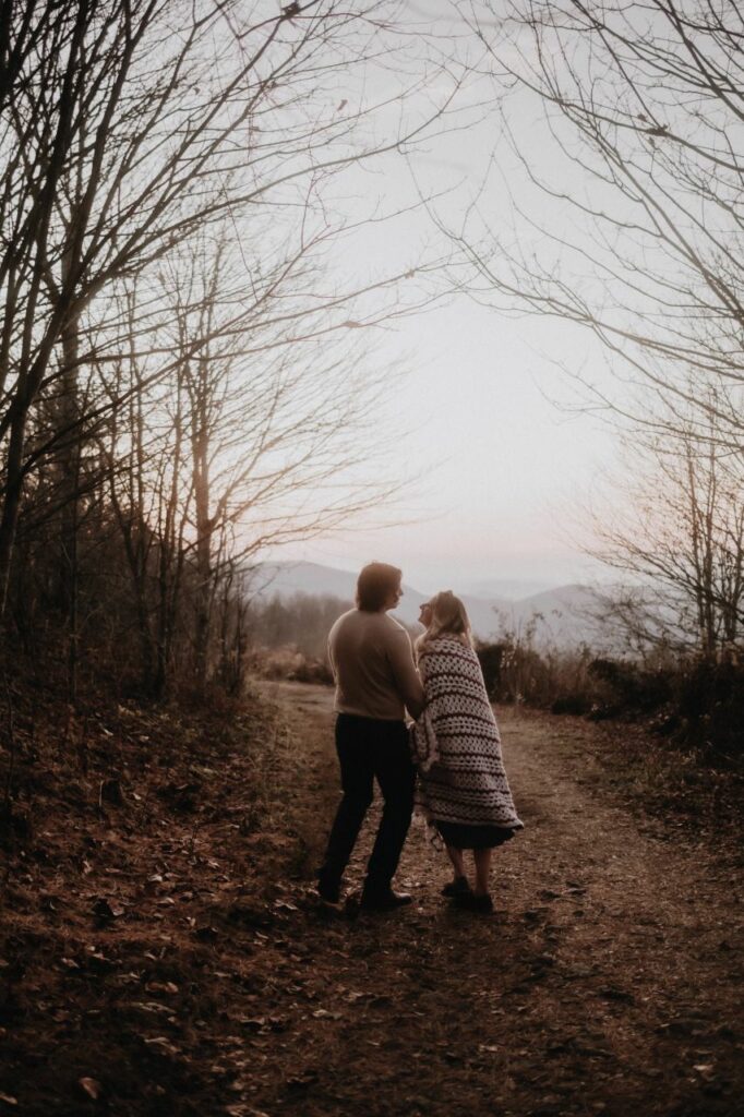 couple walking on the trail for their max patch engagement photos